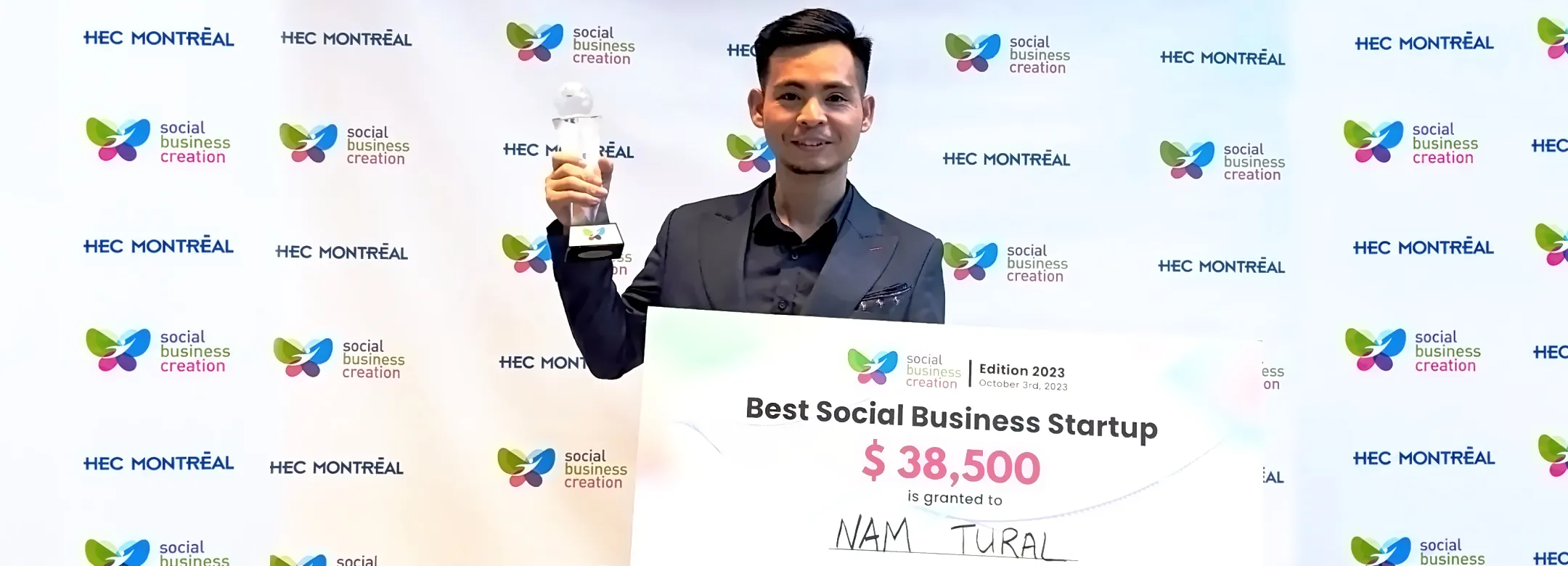 Nguyen Xuan Tai holding the Social Business Creation 2023 trophy at HEC Montréal